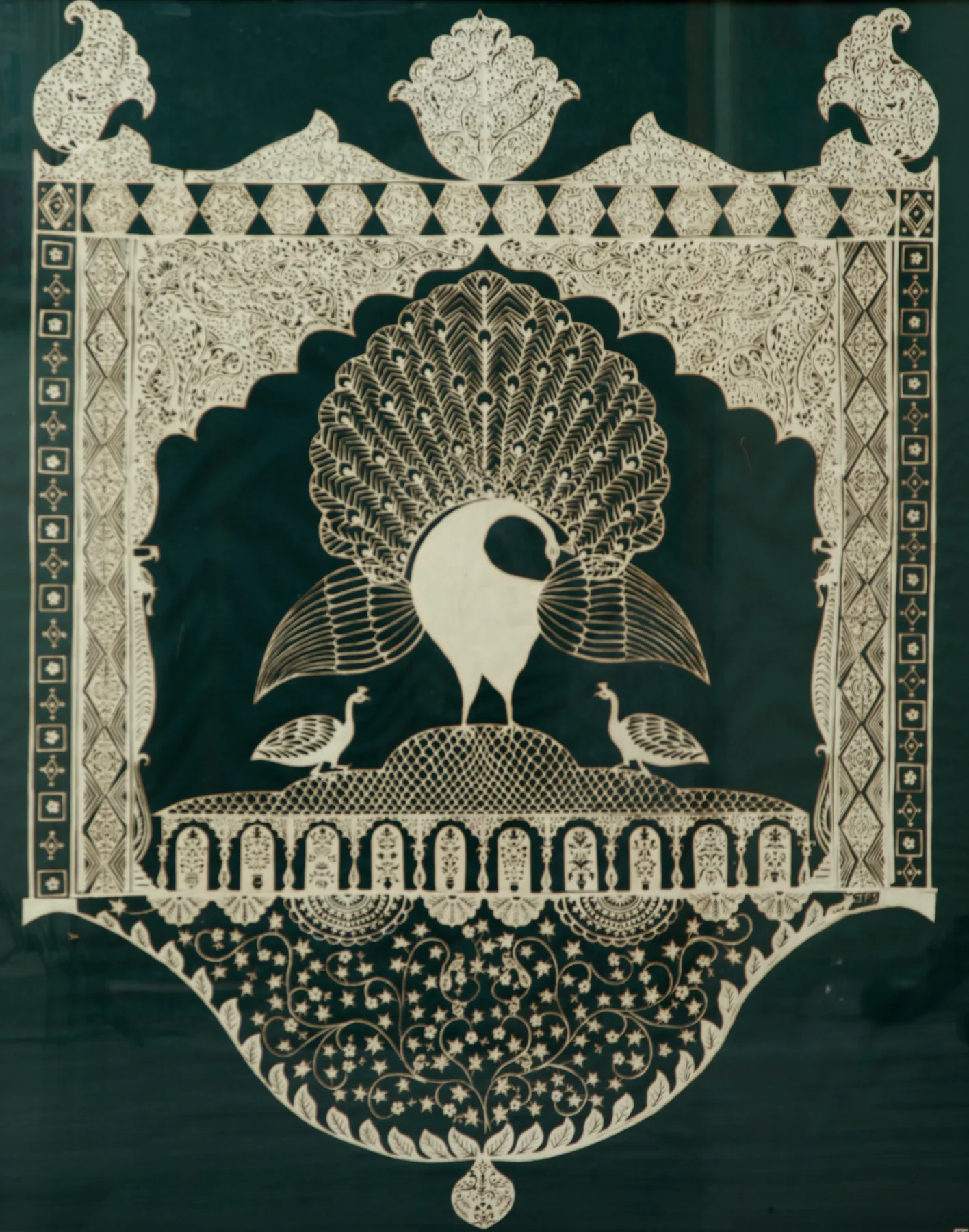 Peacock Jharokha: a white paper-cut peacock with its tail spread, inside an ornate palace window on deep green